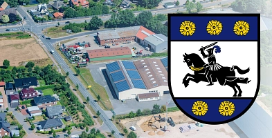 Luftbild von Harsefeld mit Neubaugebiet im Vordergrund. Rechts ist das Wappen des Flecken Harsefeld zu sehen.