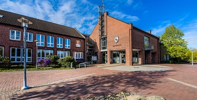 Der Vordereingang vom Rathaus der Samtgemeinde Harsefeld. Im Vordergrund ist teilweise das Wasserspiel zu erkennen.